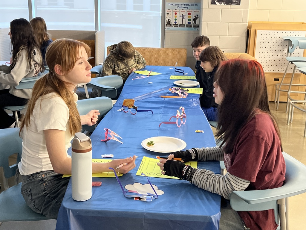 Students in French calss meet in the library to help choose a semester book.