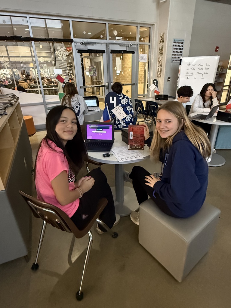Students in French calss meet in the library to help choose a semester book.