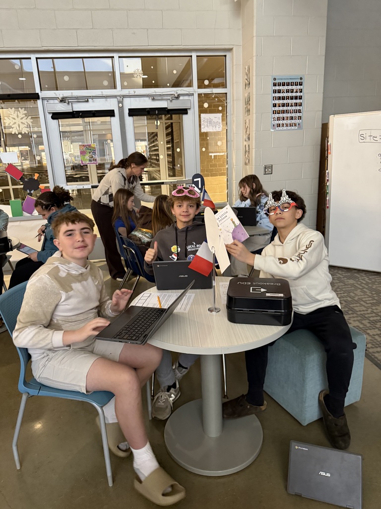 Students in French calss meet in the library to help choose a semester book.