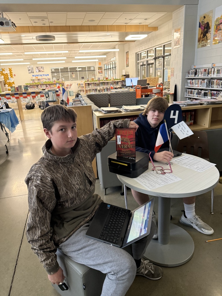 Students in French calss meet in the library to help choose a semester book.