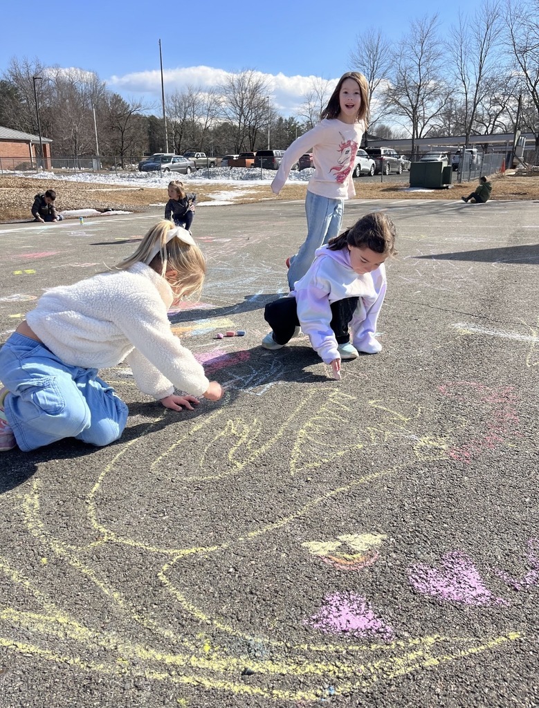 Students create chalk art drawn for Kindness Week.