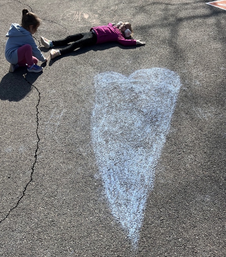 Students create chalk art drawn for Kindness Week.
