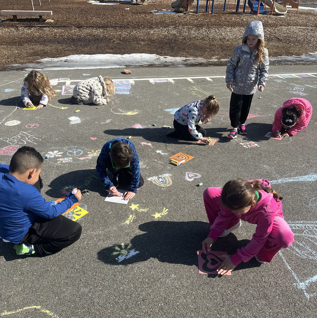 Students create chalk art drawn for Kindness Week.
