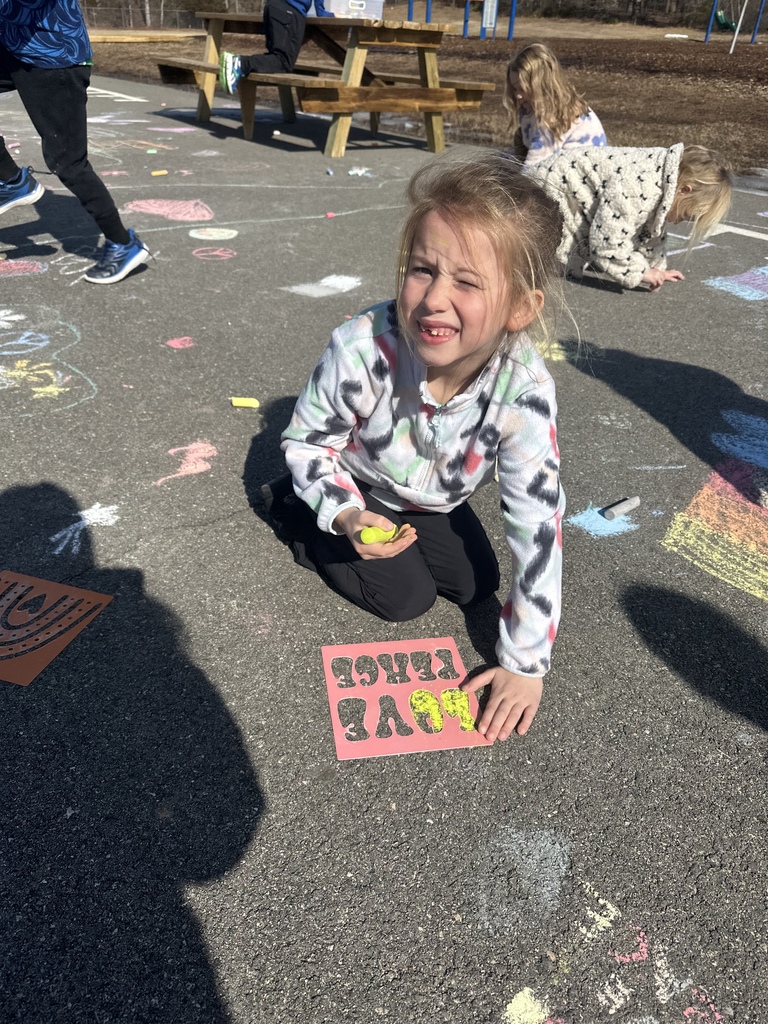 Students create chalk art drawn for Kindness Week.