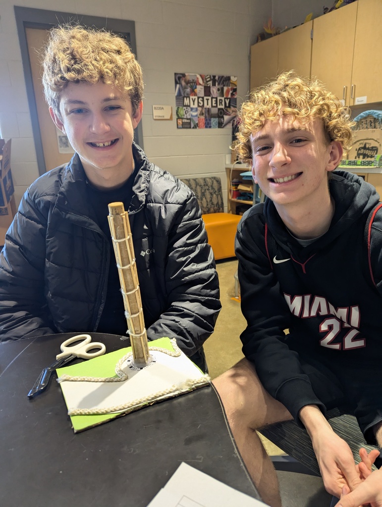 Students pose with a model of an ancient monument built on a 1:200 scale.
