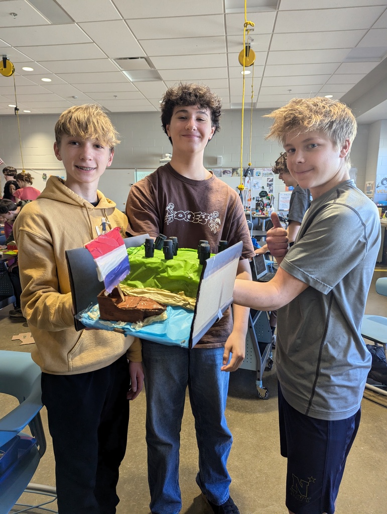 Students pose with a model of an ancient monument built on a 1:200 scale.
