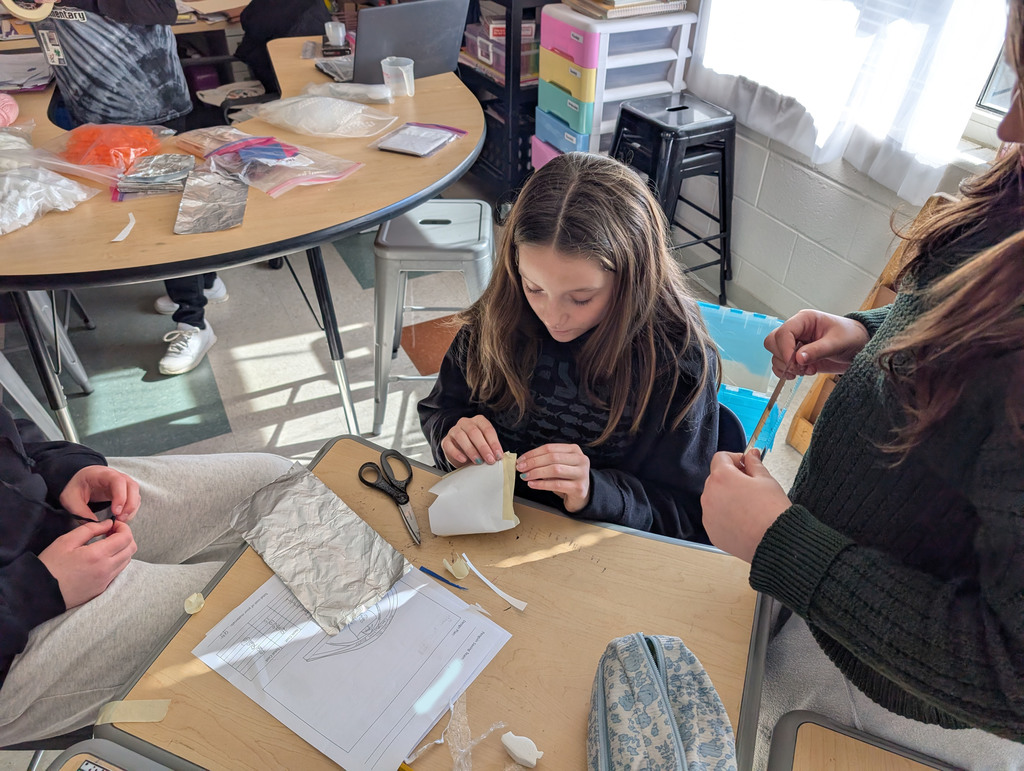 Students participate in an activity focused on thermal energy, insulators, and conductors.