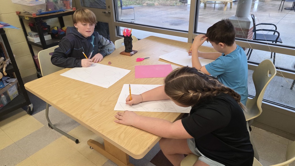 Students in art class draw ceremonial masks inspired by an African tribe.