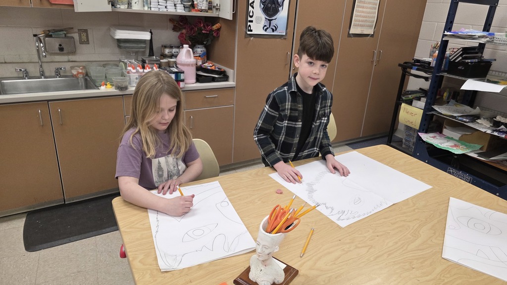 Students in art class draw ceremonial masks inspired by an African tribe.
