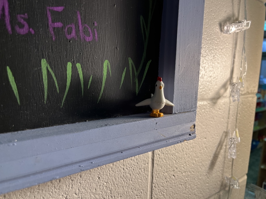 A toy chicken in a  hiding place.