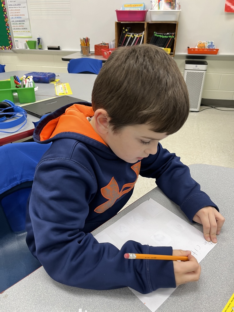 A student works on a writing assignment tied to the soft c.