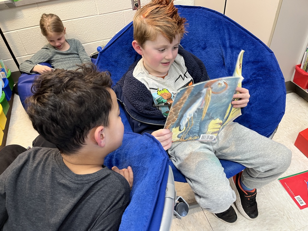 Students read books at a literacy station tied to the soft c.