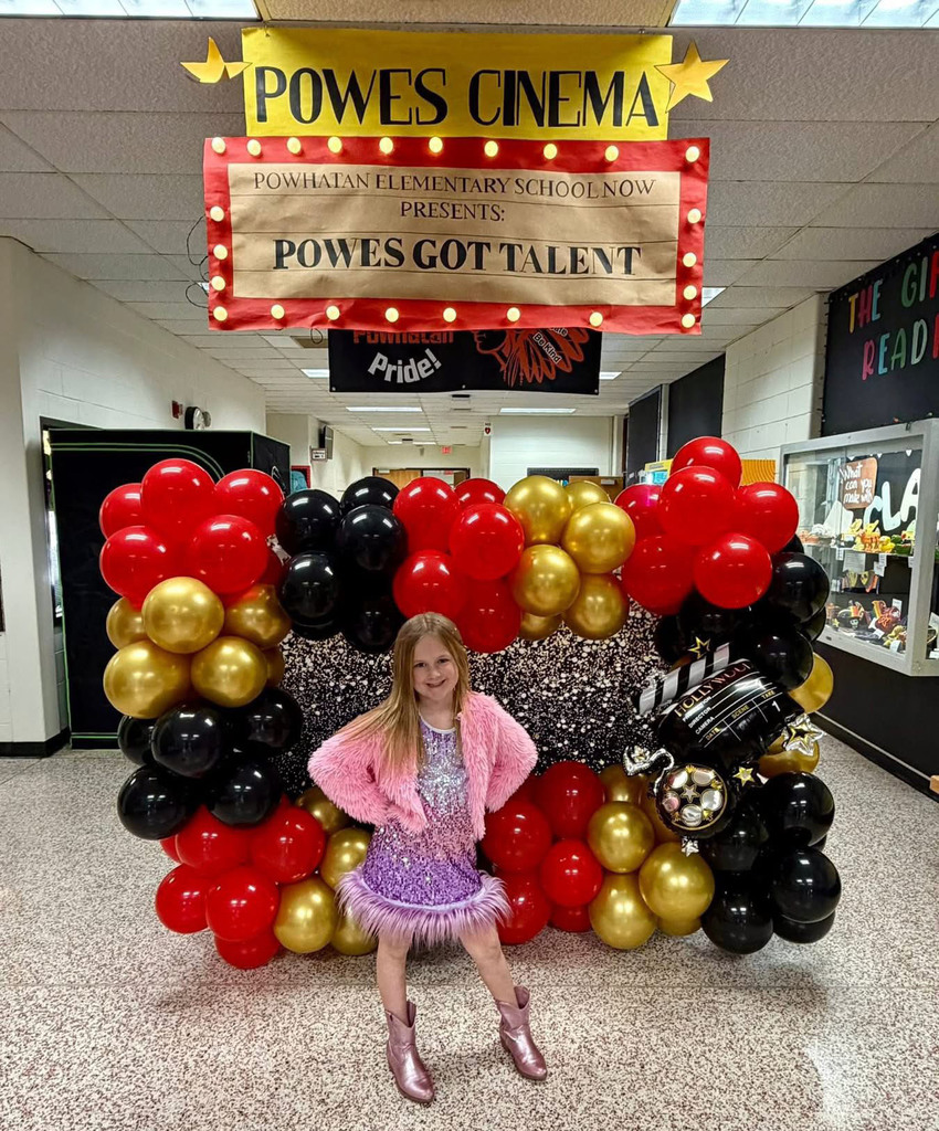 A student poses for photo at a talent show.