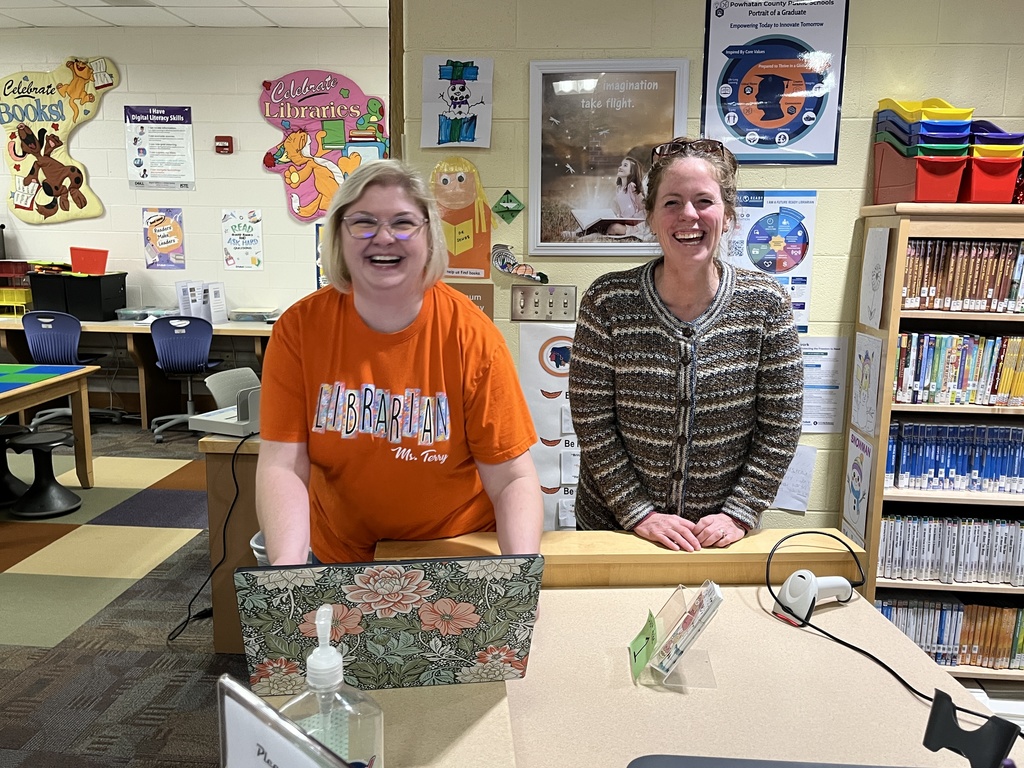 Two  women pose for a photo. 