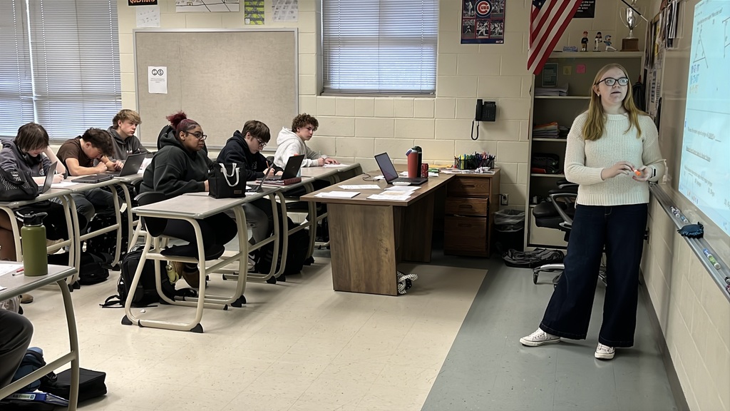 A senior participating in a Teacher for a Day activity teaches a lesson to fellow students.