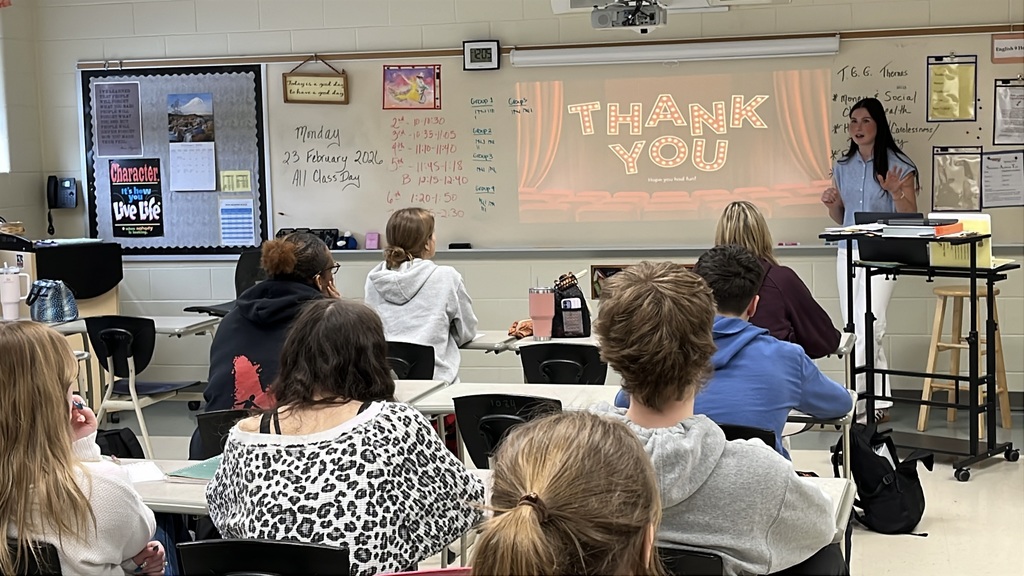 A senior participating in a Teacher for a Day activity teaches a lesson to fellow students.