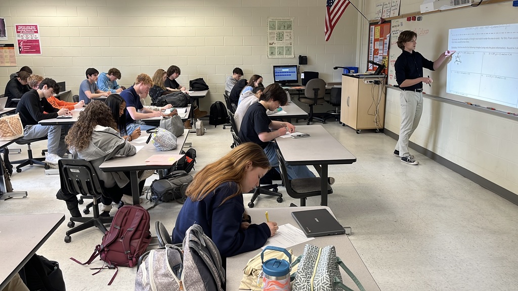 A senior participating in a Teacher for a Day activity teaches a lesson to fellow students.