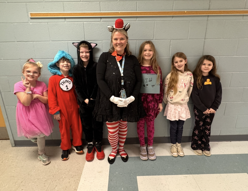 A teacher and her students dress in Dr. Seuss themed outfits.