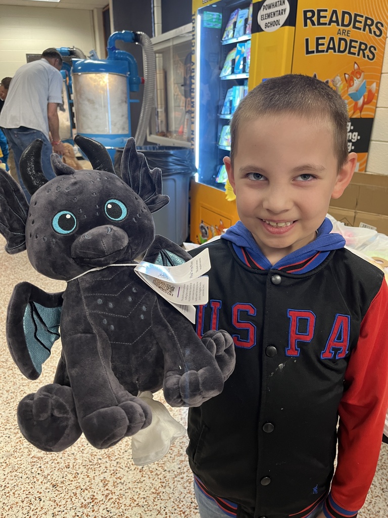 A child poses with a new stuffed animal.