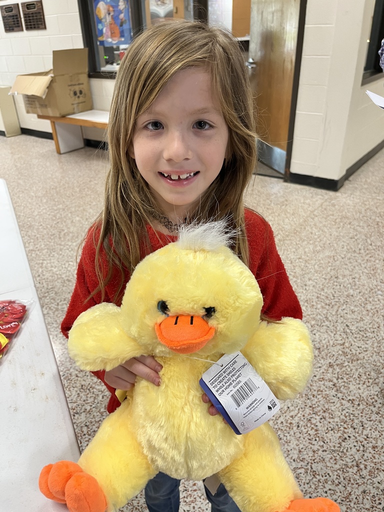 A child poses with a new stuffed animal.