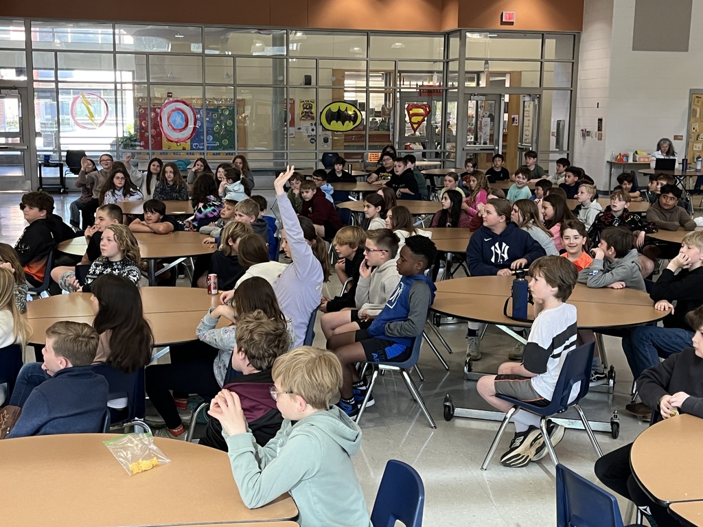 A group of students listed to detectives speak  about cybersecurity in a school assdembly. 