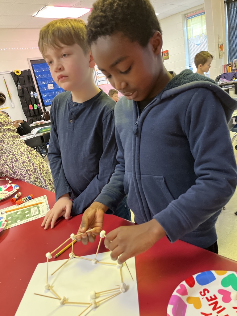 Students use marshmallows and toothpicks to build geometric shapes.