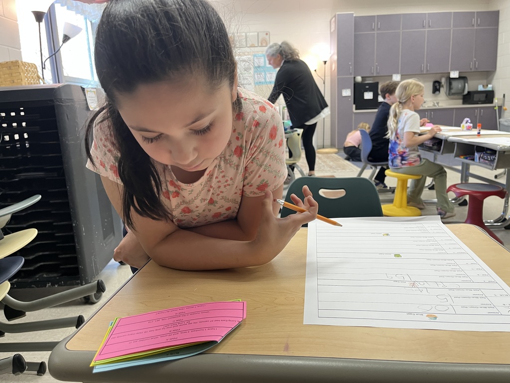 A child works on an egg-hunt themed math activity about place values.
