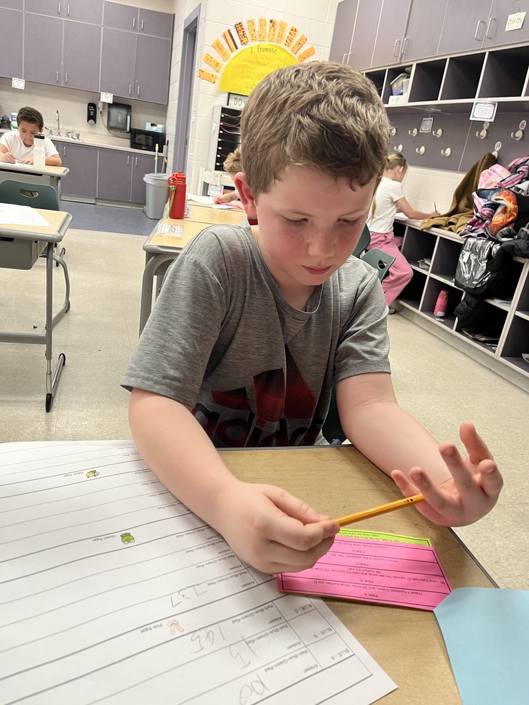 A child works on an egg-hunt themed math activity about place values.