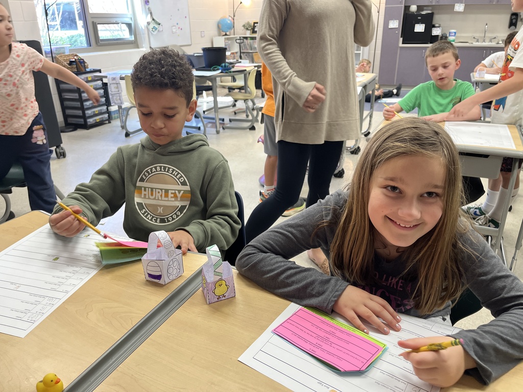 Students work on an egg-hunt themed math activity about place values.