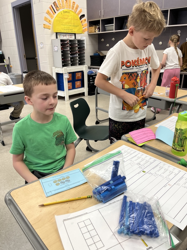 Students work on an egg-hunt themed math activity about place values.