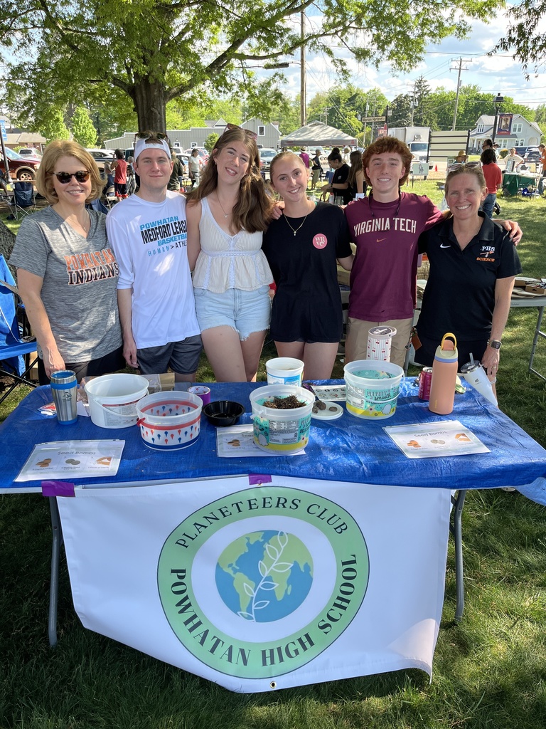 A group  of teens and adults pose for a photo.