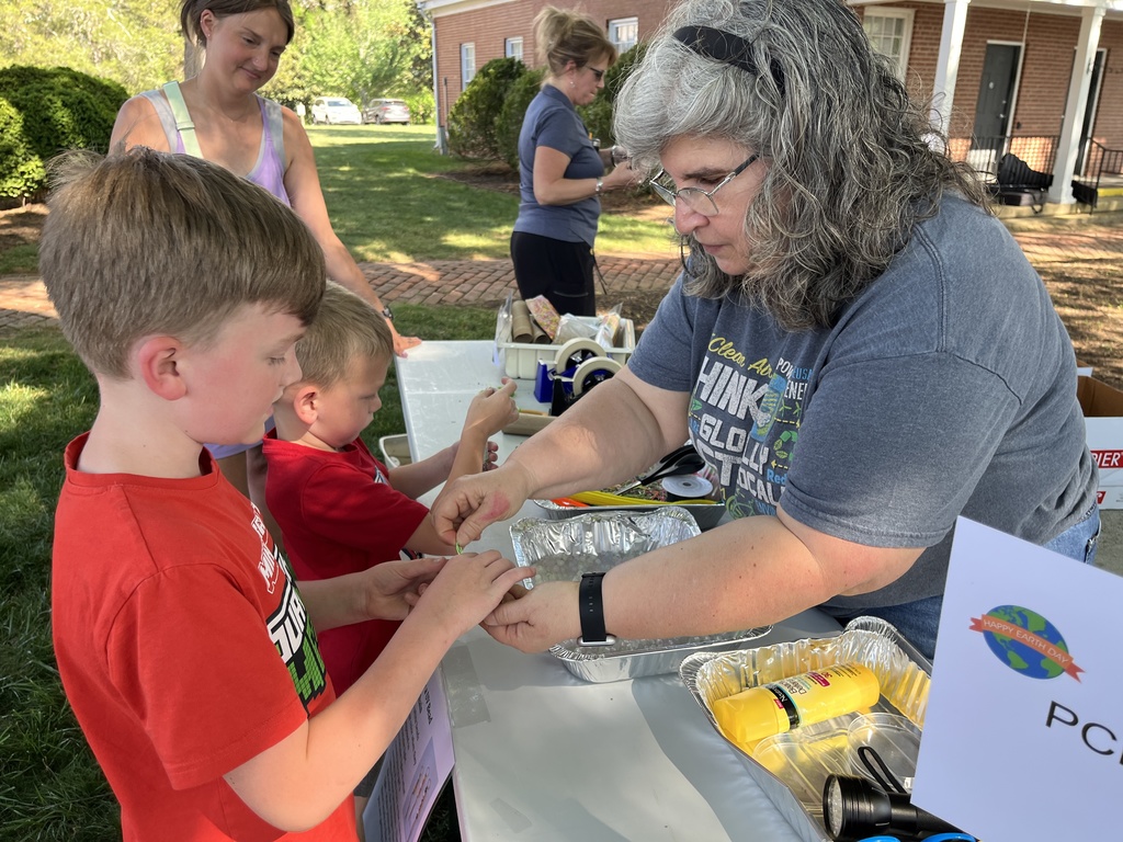 A family visits a booth at an Eartyh Day Festival. 