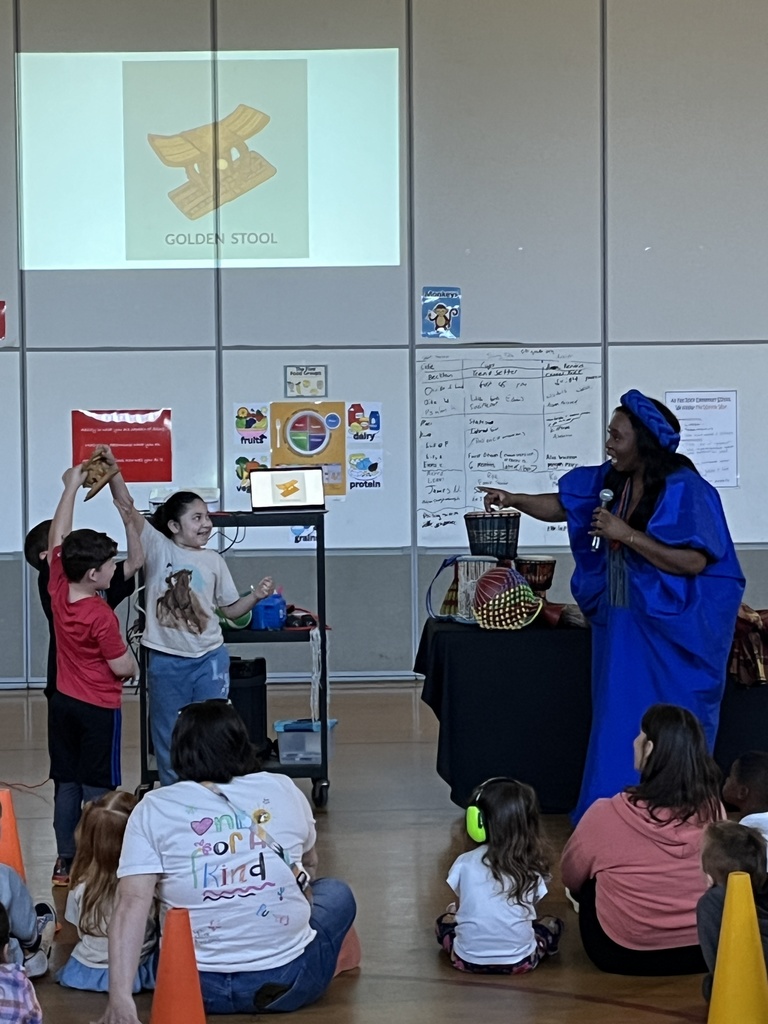 An African storyteller leads a school assembly in an elementary gym and uses student volunteers.