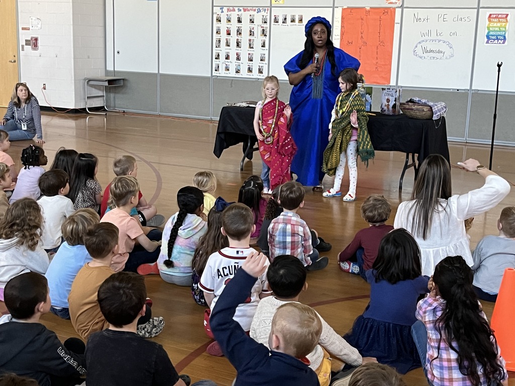 An African storyteller leads a school assembly in an elementary gym and uses student volunteers.