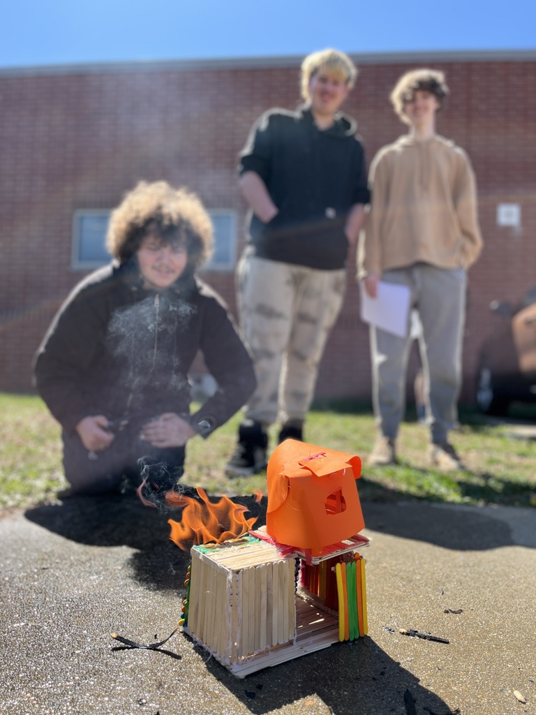 Students observe a burning popsicle house as part of a unit on arson in their forensic science class.
