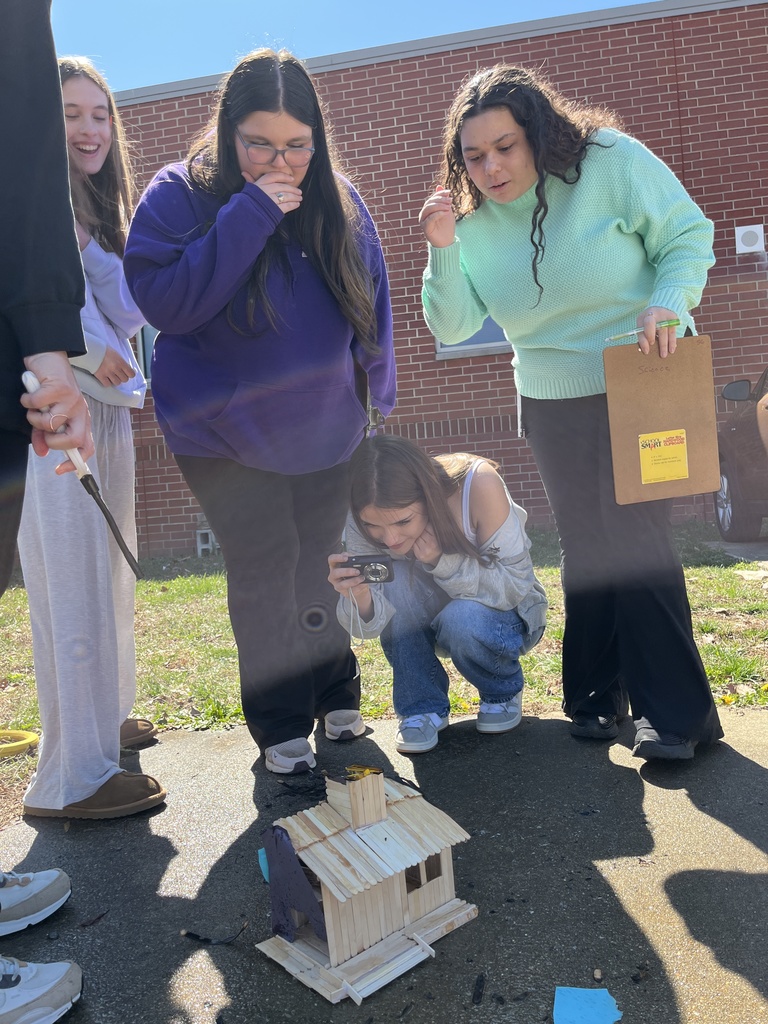 Students observe a burning popsicle house as part of a unit on arson in their forensic science class.