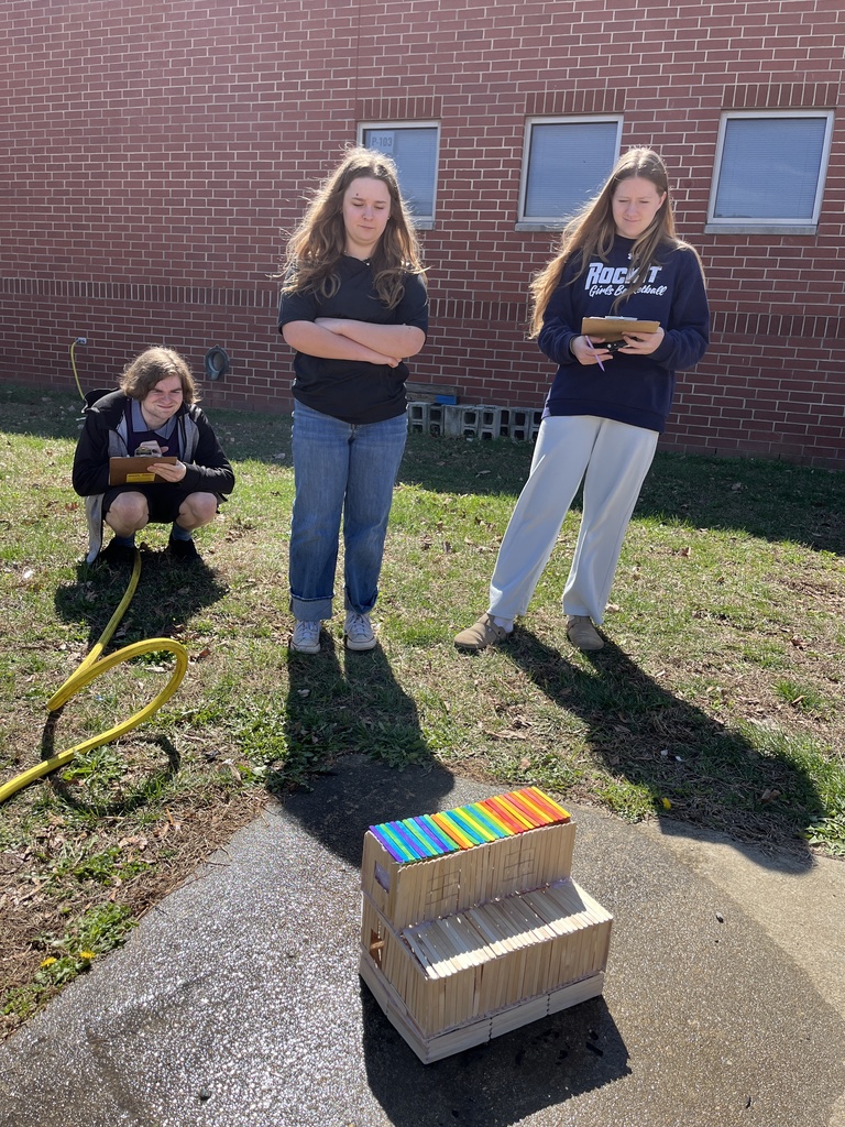 Students observe a burning popsicle house as part of a unit on arson in their forensic science class.