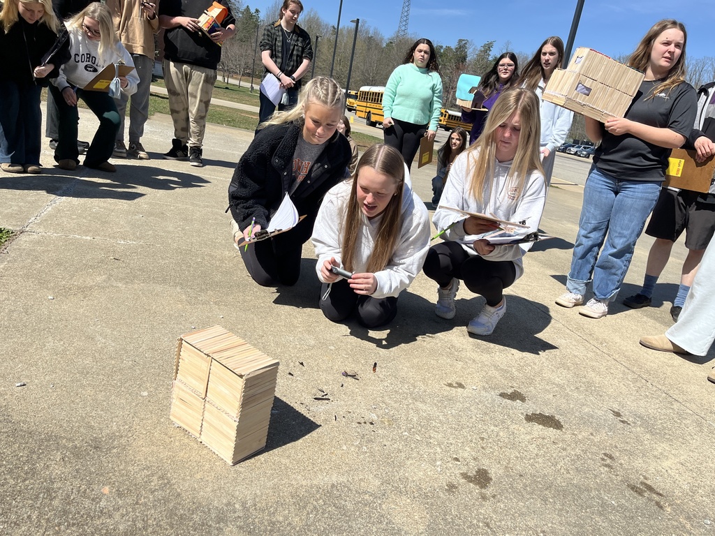 Students observe a burning popsicle house as part of a unit on arson in their forensic science class.