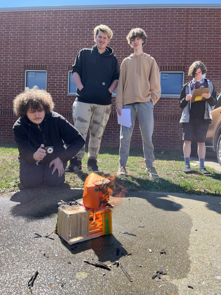 Students observe a burning popsicle house as part of a unit on arson in their forensic science class.