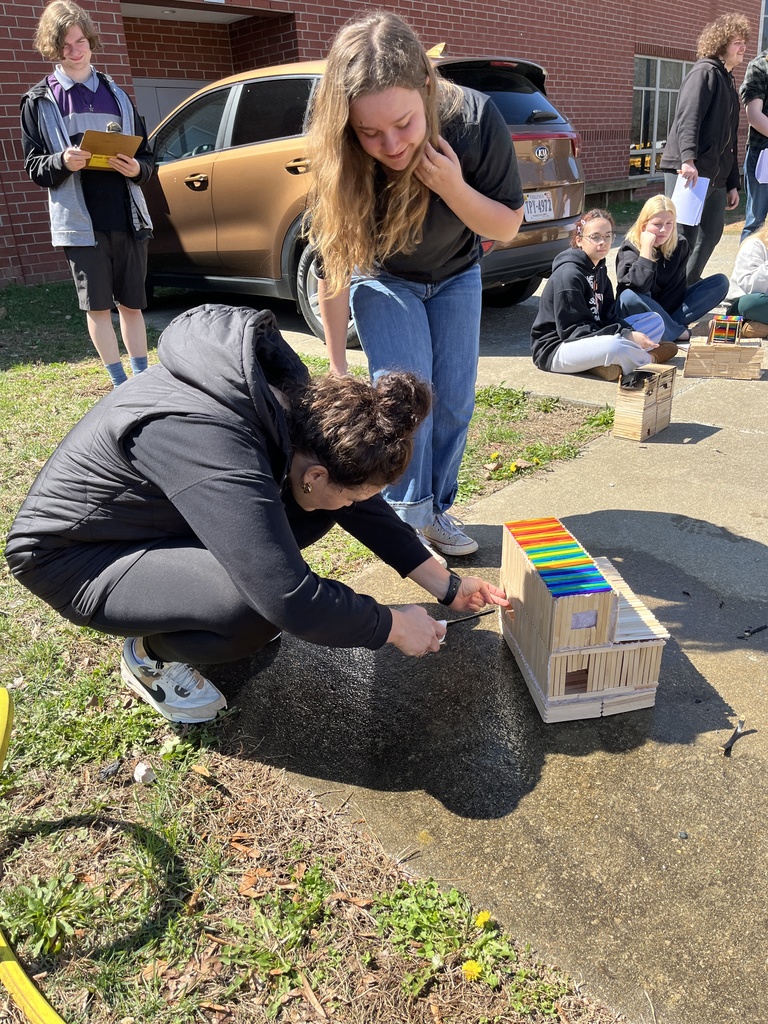 A teacher starts a fire in a popsicle house as part of a unit on arson in her forensic science class while her students observe.