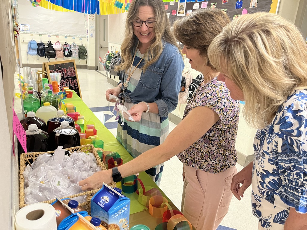 Staff members make drinks at a refresh station created by students.
