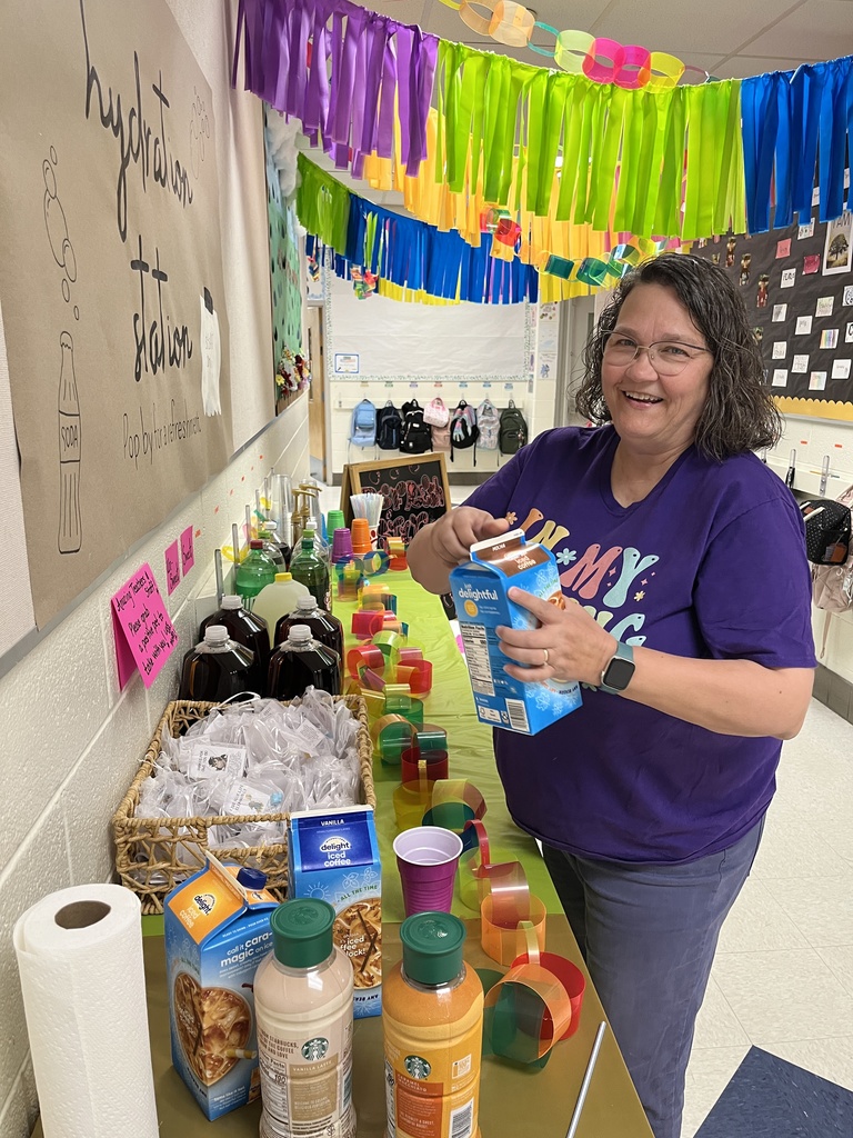 A staff member makes a drink at a refresh station created by students.