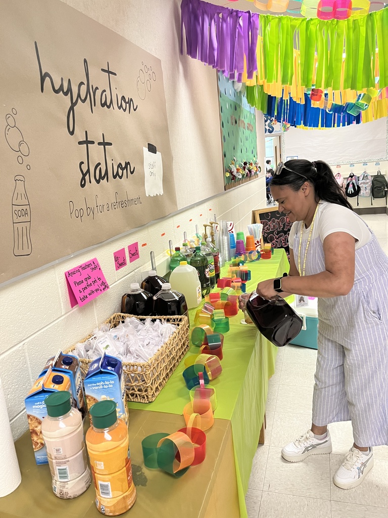 A staff member makes a drink at a refresh station created by students.