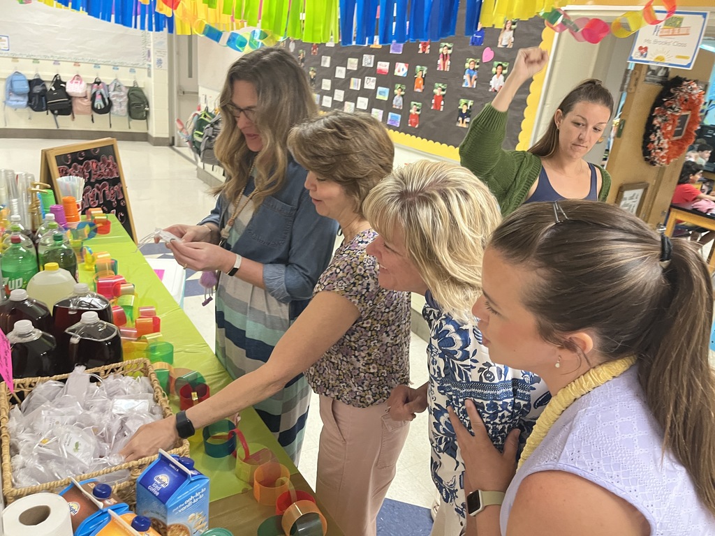 Staff members make drinks at a refresh station created by students.