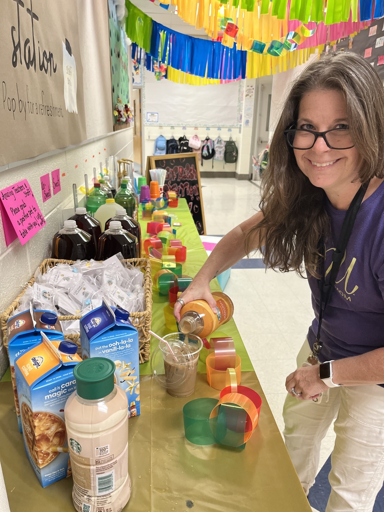 A staff member makes a drink at a refresh station created by students.