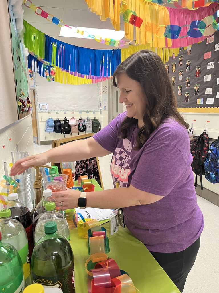 A staff member makes a drink at a refresh station created by students.