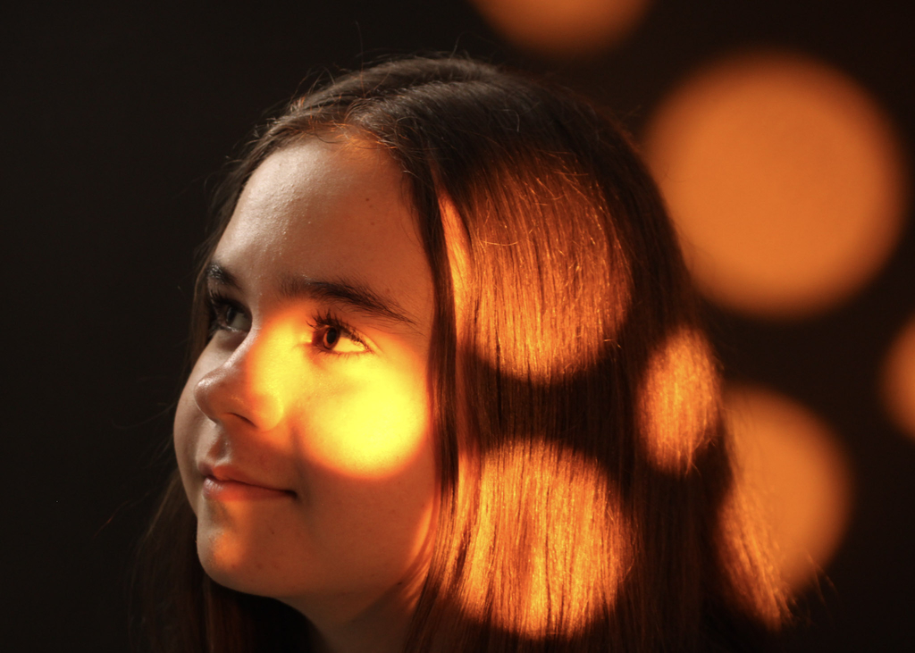 An artistic portrait photograph using lighting. 