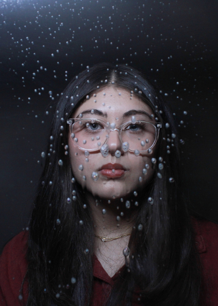 An artistic portrait photograph using propts and  lighting. 