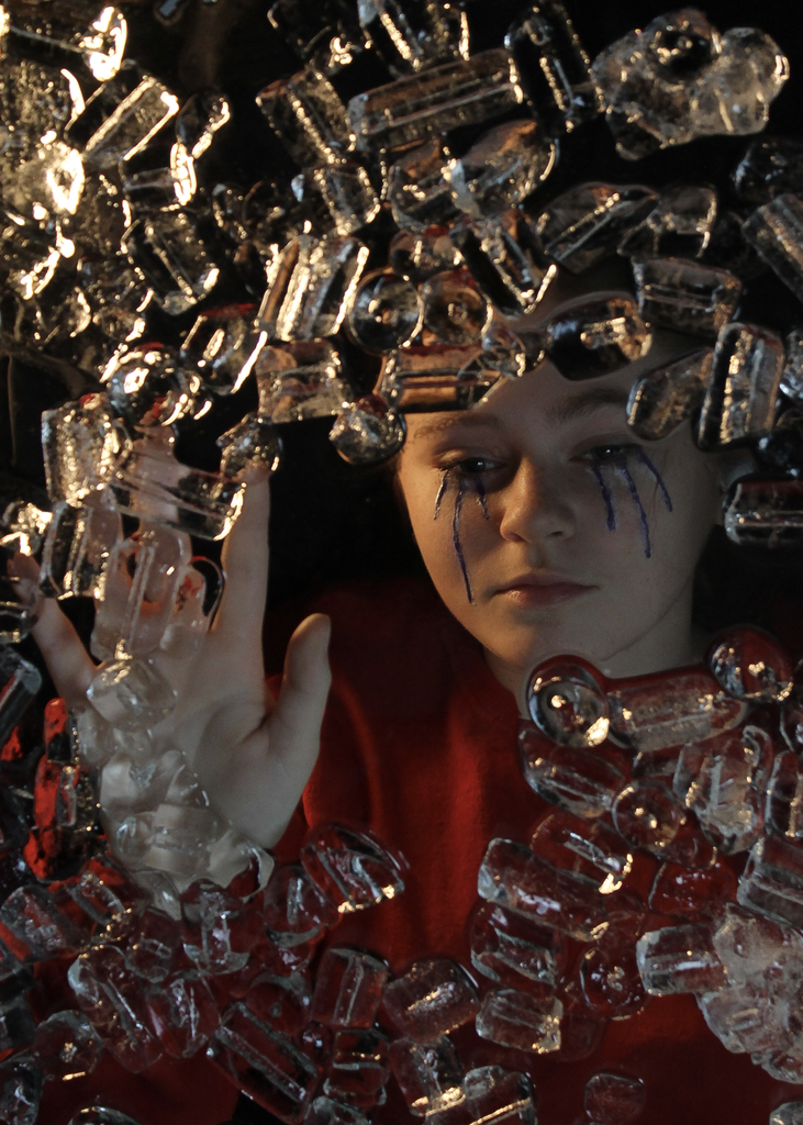 An artistic portrait photograph using ice and lighting. 