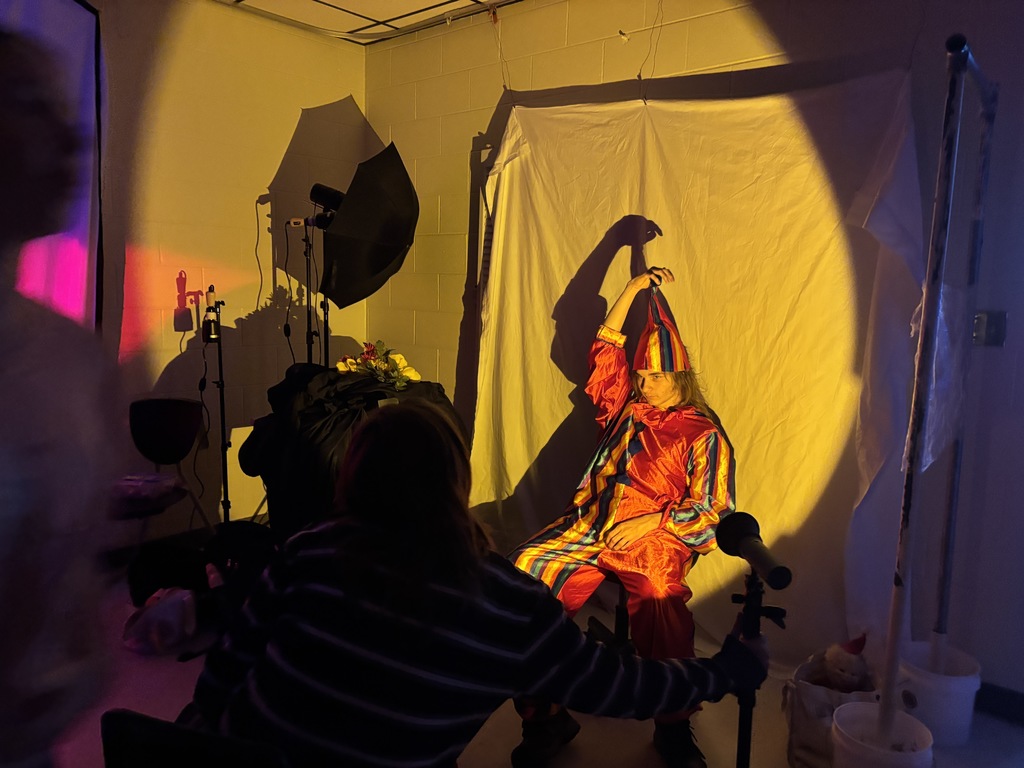 Behind the scenes photo of a student creating an artistic portrait photograph. 